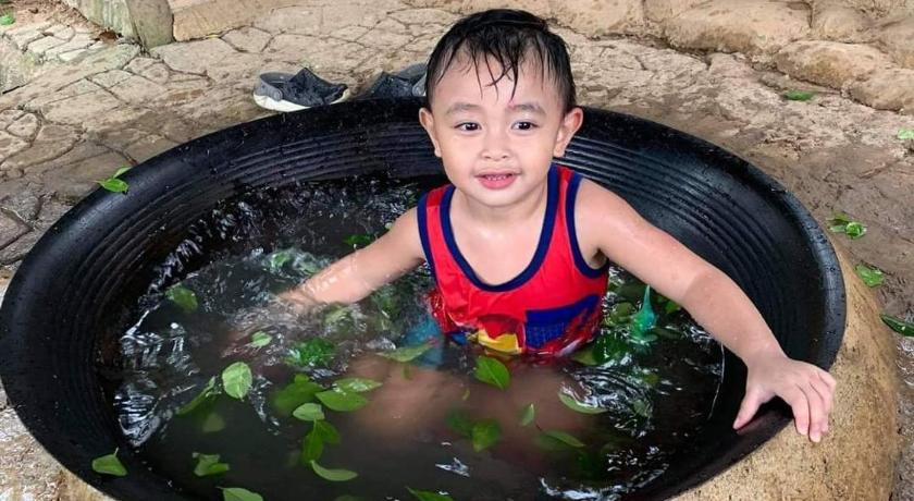 a little boy in a pool of water with a bucket, Singalong Salceda's Mountain View Kawa Bath and Garden Camp Tent Adventure in Antipolo