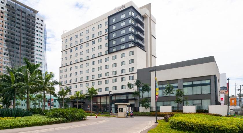 a large building with a lot of windows, Seda Abreeza Hotel in Davao City
