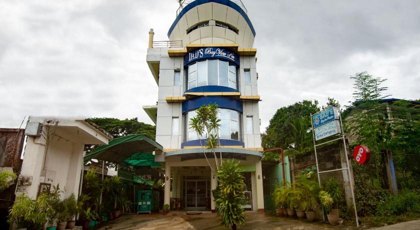 a large building with a clock on top of it, OYO 554 Dads Bayview Pension                                                                     in Palawan