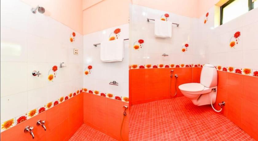 a bathroom with a toilet, sink, and shower stall, OYO 6665 Thomson Regency in Kochi