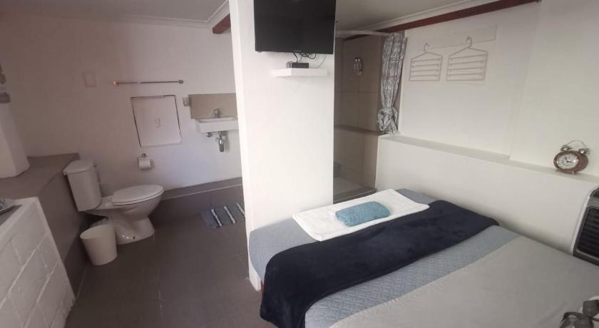 a hotel room with a television and a bed, The nest in East London