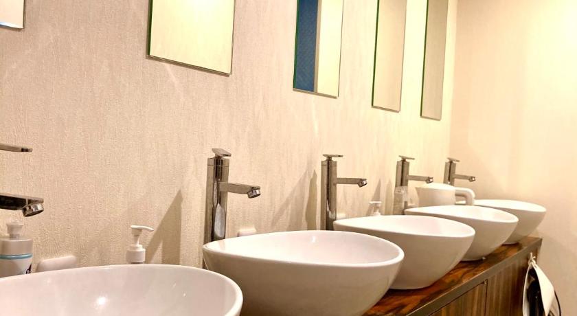 a bathroom with two sinks and a large mirror, bnbplus shinbashi in Tokyo