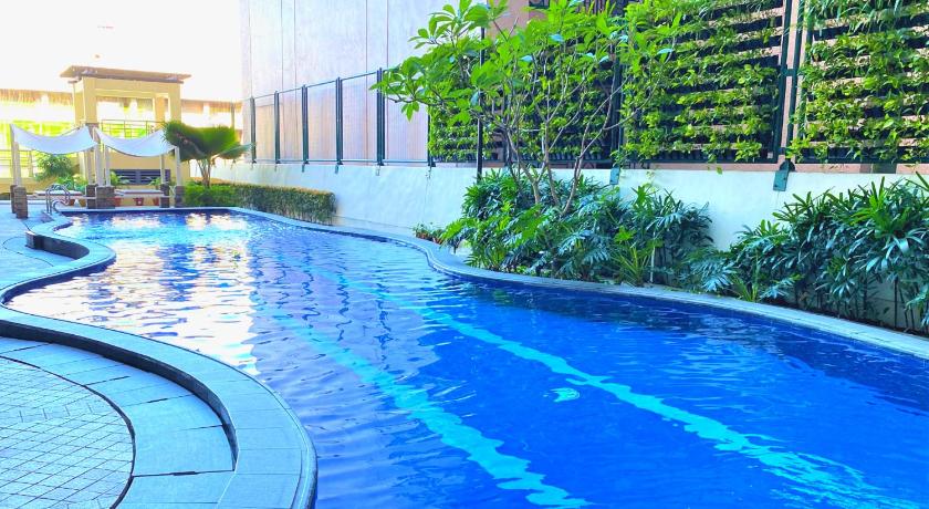 a pool of water with a blue sky, One Pacific Place Serviced Residences – Multiple-Use Hotel in Manila