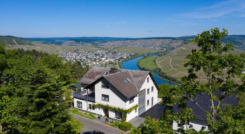 a house with a view of the ocean and mountains, Gastehaus-Weingut Loersch in Leiwen
