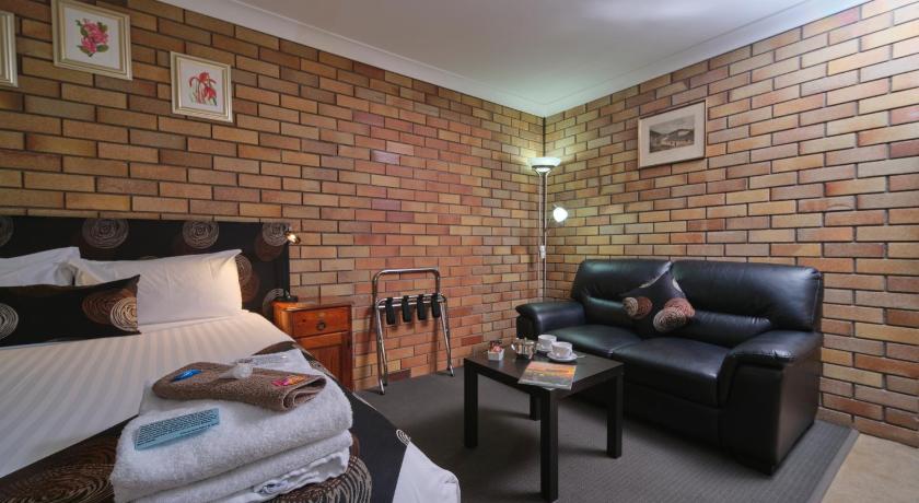 a living room with a couch, coffee table and a television, City View Motel Warwick in Warwick