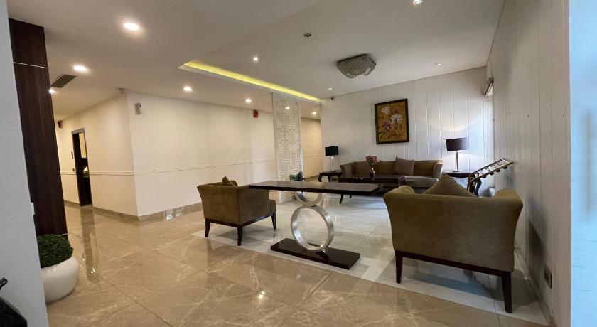 a living room filled with furniture and a large window, Central Boutique Hotel in Moradabad