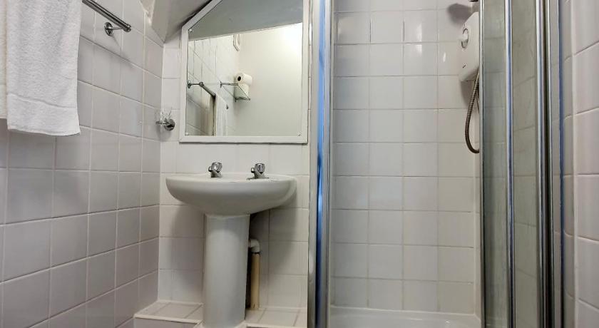 a bathroom with a shower, sink, and toilet, The Hedley Townhouse in Bournemouth