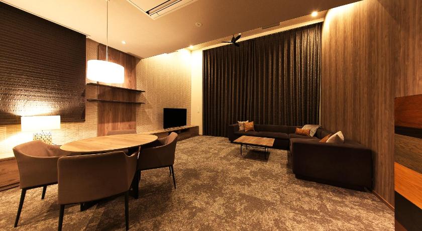 a living room filled with furniture and a large window, Winery Hotel & Condominium HITOHANA in Furano