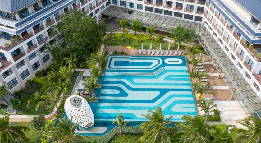 a large swimming pool in front of a large building, The Secret Con Dao in Côn Đảo Islands