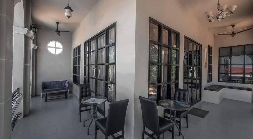 a living room filled with furniture and a large window, Je t'aime cafe & villa in Sing Buri