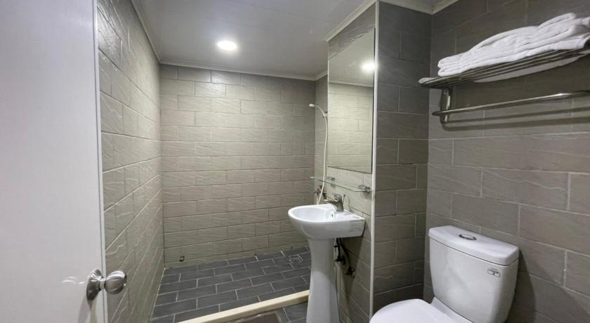 a bathroom with a toilet and a sink, A22 Wei Lu Hotel in Taoyuan