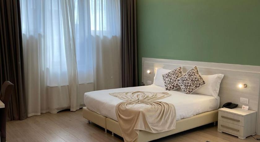 a bedroom with a bed and a dresser, Palazzo Marignano Hotel in Melegnano