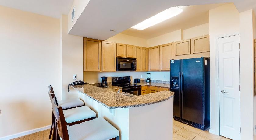 a kitchen with a refrigerator, stove, sink and microwave, The Palms of Destin in Destin (FL)
