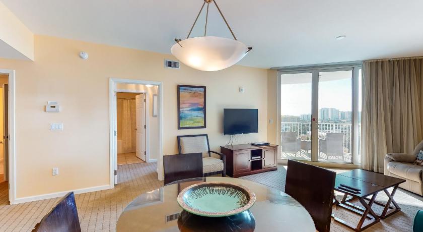 a living room filled with furniture and a large window, The Palms of Destin in Destin (FL)