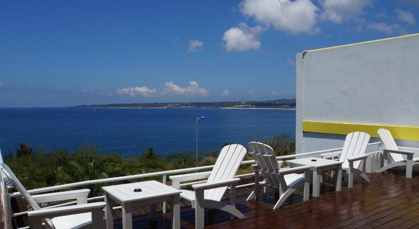a row of chairs sitting on top of a beach, Kenting Nanwan Hotel 南灣飯店 in Kenting