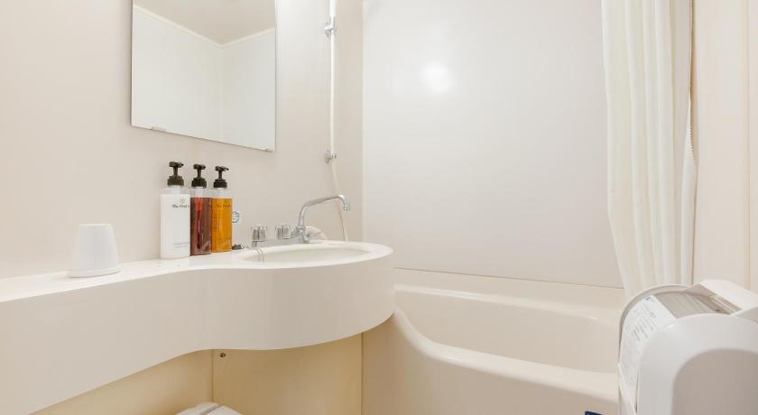 a bathroom with a sink, toilet and bathtub, The OneFive Okayama in Okayama