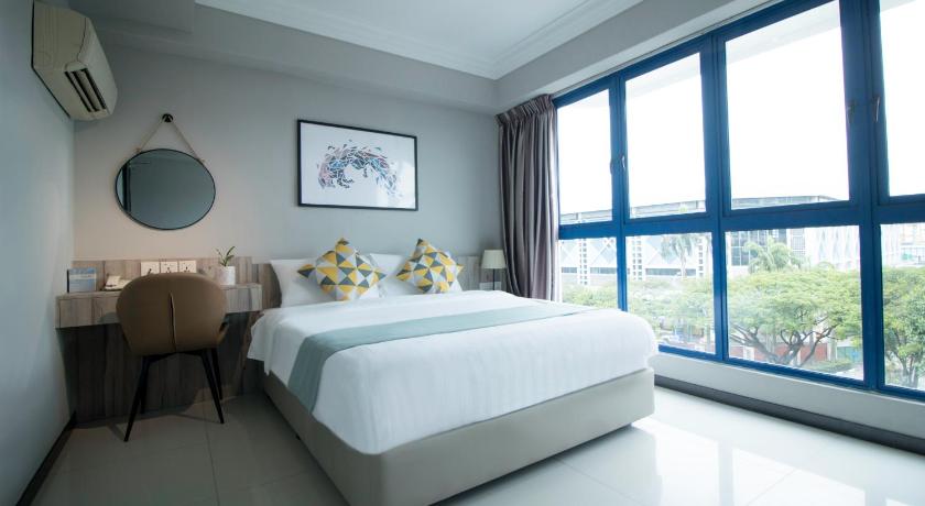 a bedroom with a large bed and a large window, Harbour Ville Hotel - SG Clean Certified in Singapore