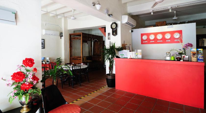 a red room with a red couch and a red table, Red Inn Court in Penang