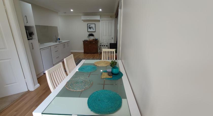 a kitchen with a table, chairs, and a refrigerator, Se-Ayr BnB at Lighthouse in Port Macquarie