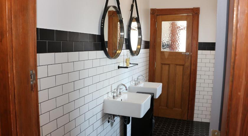 a bathroom with a sink and a mirror, Guildford Hotel in Sydney