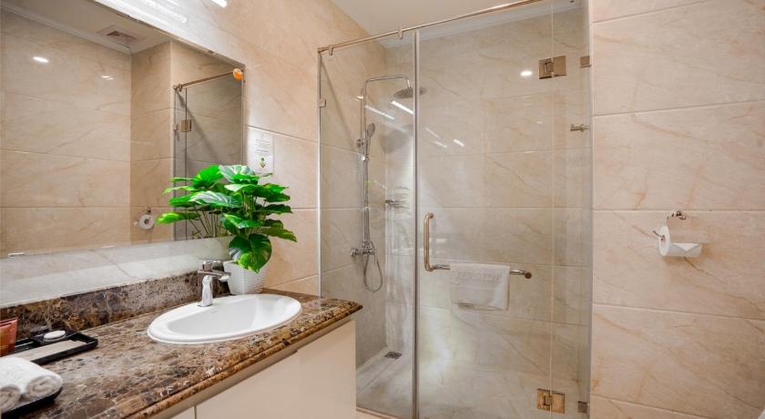 a bathroom with a shower, sink, and toilet, Riverside Hotel Quang Binh in Đồng Hới (Quảng Bình)