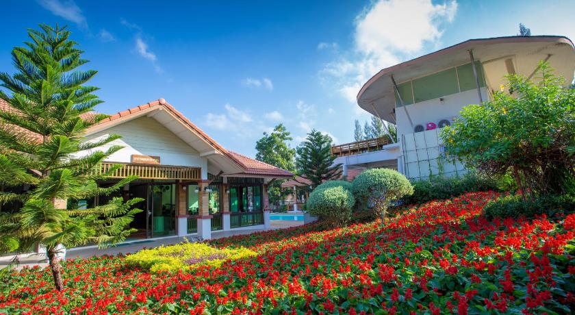 a garden filled with lots of flowers in front of a building, Thongsathit Hill Resort KhaoYai in Khao Yai