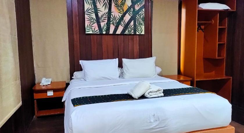 a bedroom with a bed and a desk, Exotic Komodo Hotel in Labuan Bajo