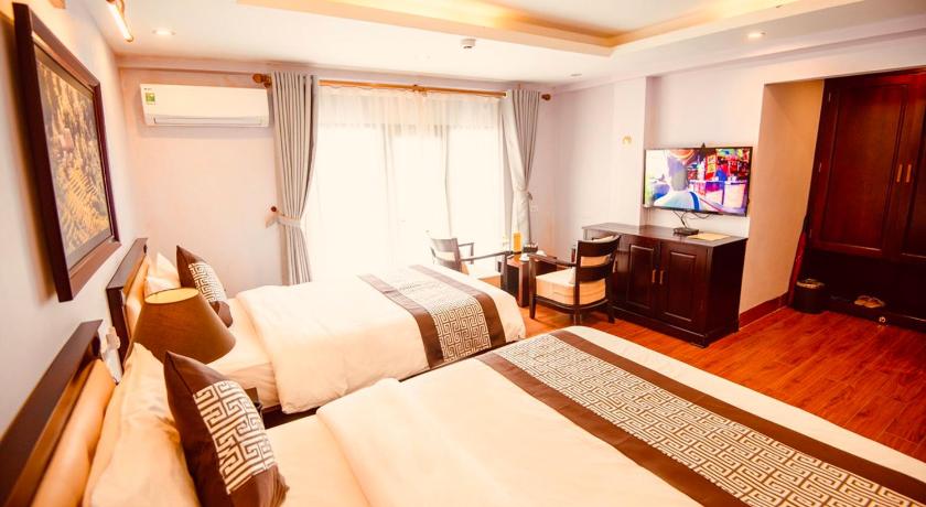 a hotel room with a bed and a television, Le Bordeaux Sapa Hotel  in Sapa