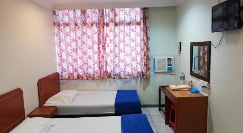 a bedroom with a bed and a desk, Sri Gate Hotel in Dungun