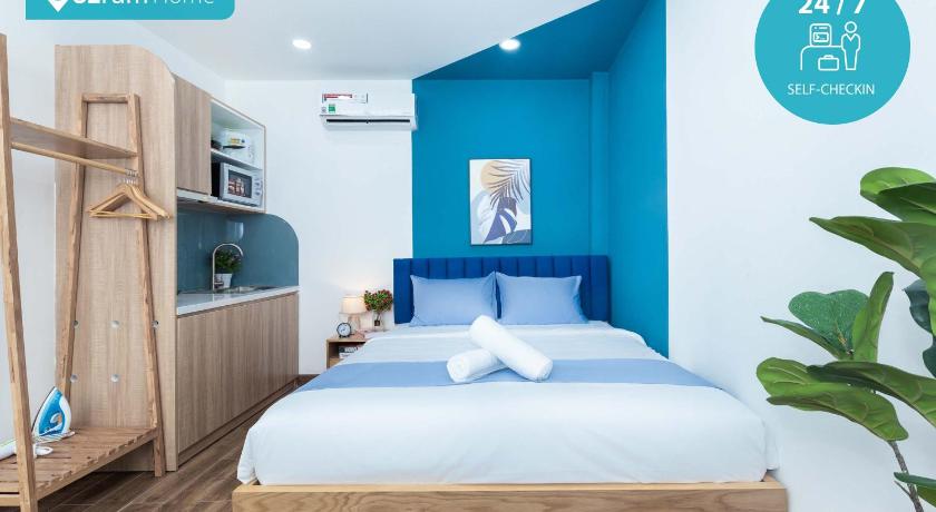 a bedroom with a bed and a television, Cozrum Homes Charming Corner in Ho Chi Minh City