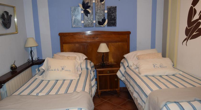 a bedroom with two beds and two lamps, Hotel Casa de la Fuente in Alcorisa