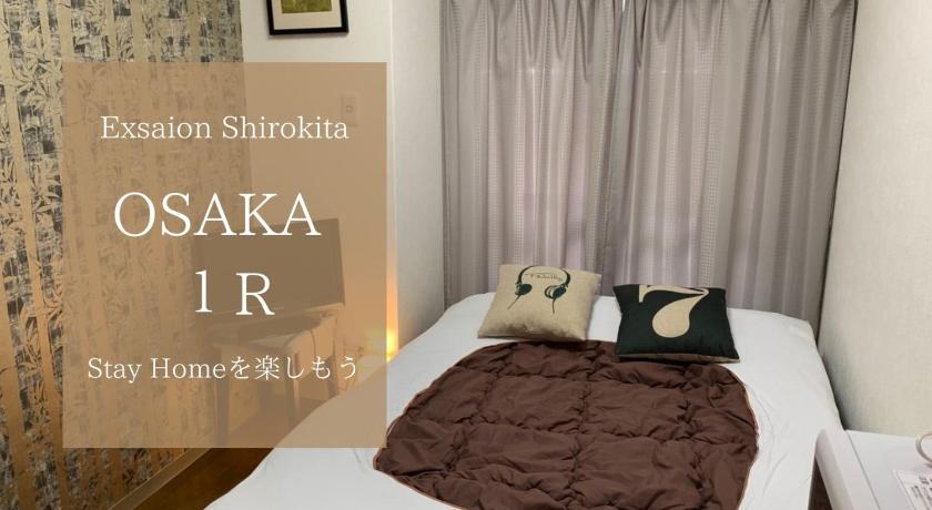 a bed that has a picture of a cat on it, EX Shirokitakoen Apartment 108 in Osaka