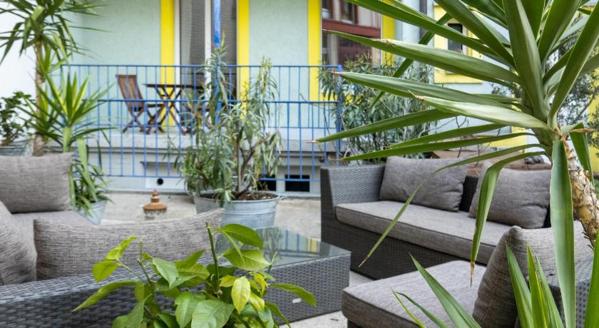a living room filled with furniture and plants, Apartments Spalenring10 in Basel