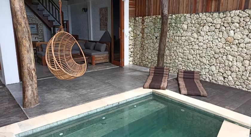 a pool with a tub and a chair in it, Divinity Villas - Uluwatu, Bali in Bali