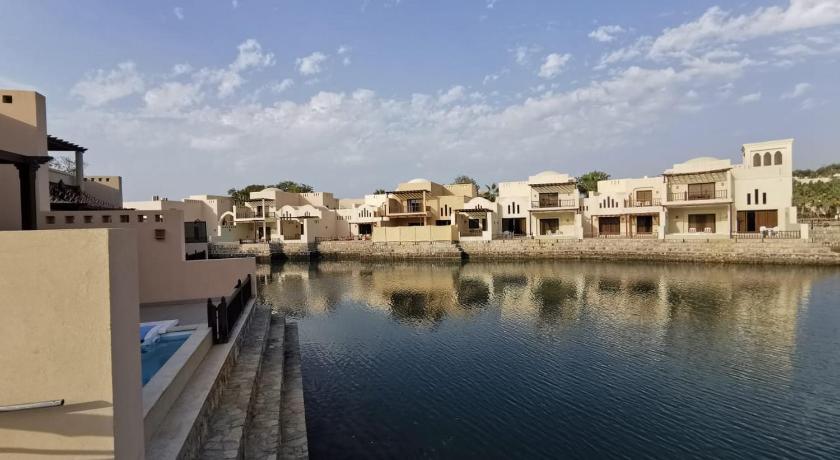 a large body of water with buildings, The Cove Rotana Resort Ras Al Khaimah in Ras Al Khaimah