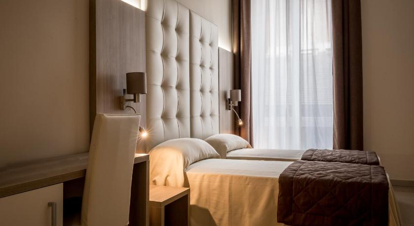 a hotel room with a bed and two lamps, Riva Superior in Genoa