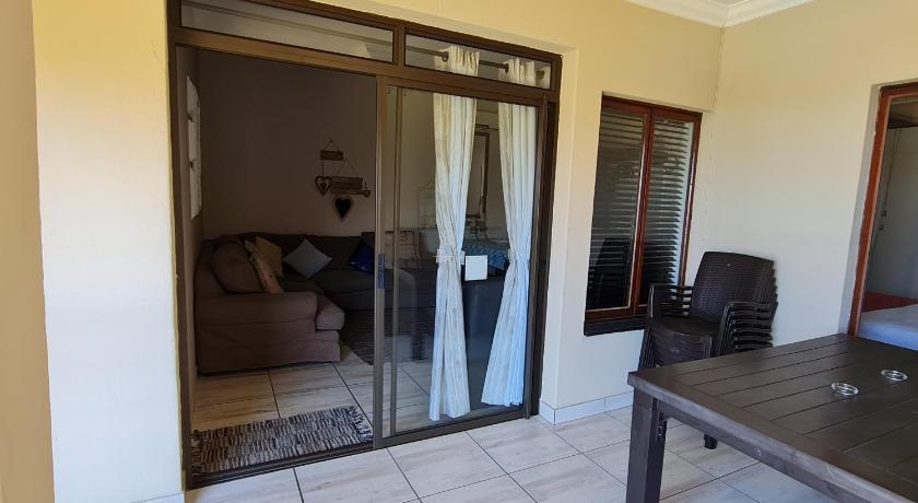a bathroom with a mirror and a walk in shower, Cabana Del Mar 69 in Durban