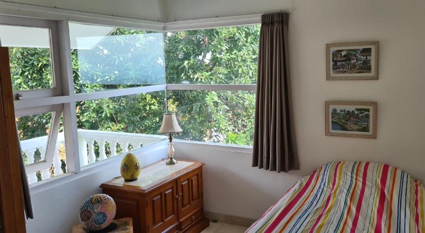 a bedroom with a bed and a window, Villa Marbelice in Bandung