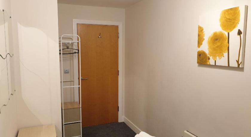 a room with a toilet, a sink, and a closet, Birmingham Garnet, 3 bedroom Apartment in Birmingham
