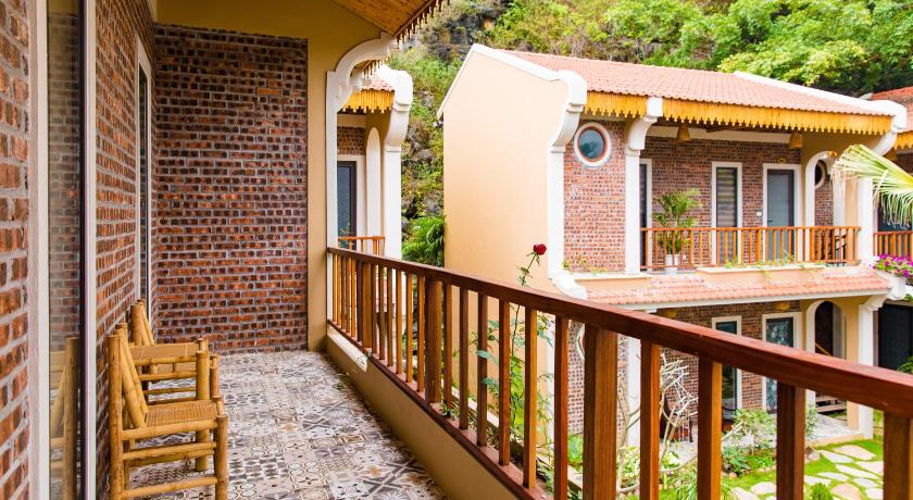 a brick building with stairs leading up to a balcony, Trang An Aroma Homestay in Ninh Bình