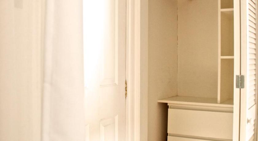 a room with a white door and a white toilet, Brookview Guest House in London