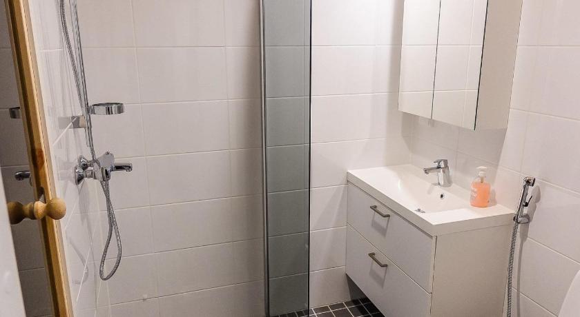 a bathroom with a shower, sink, and toilet, Holiday Home Skistar 105 in Levi