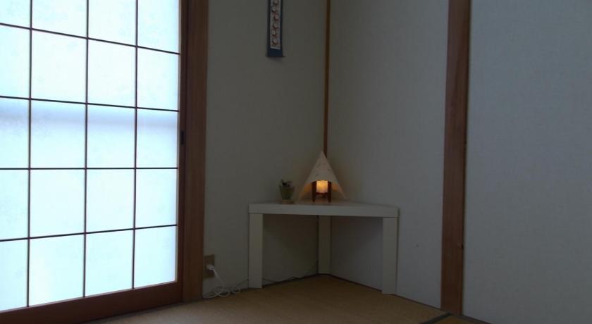 a room with a wooden floor and a mirror, Lodge Stack Point in Fujikawaguchiko