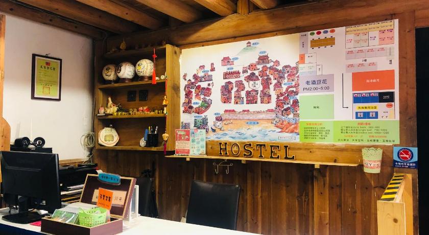 a kitchen with a sign on the wall, Matsu 1st Hostel in Matsu Island