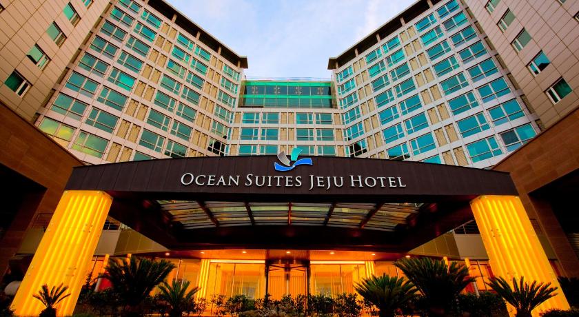 a large building with a clock on the front of it, Ocean Suites Jeju Hotel in Jeju