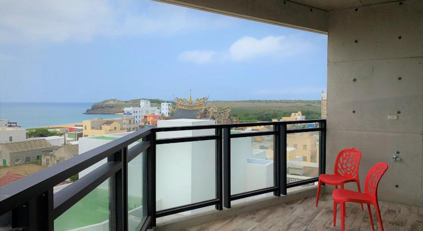 a view from a balcony of a building with a view of the ocean, LOL B&B in Penghu