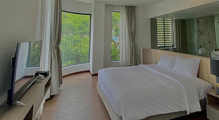 a bedroom with a large bed and a large window, Mansion Park Hotel in Bien Hoa (Dong Nai)
