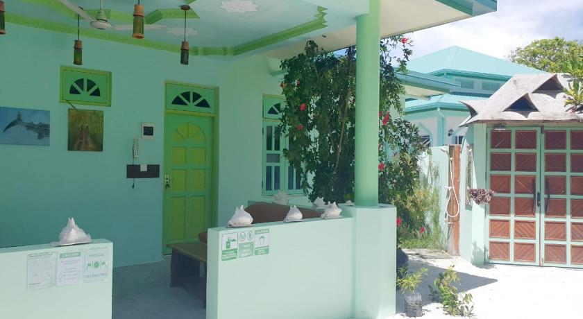 a green and white kitchen with a green wall, Kuri Inn in Maldive Islands