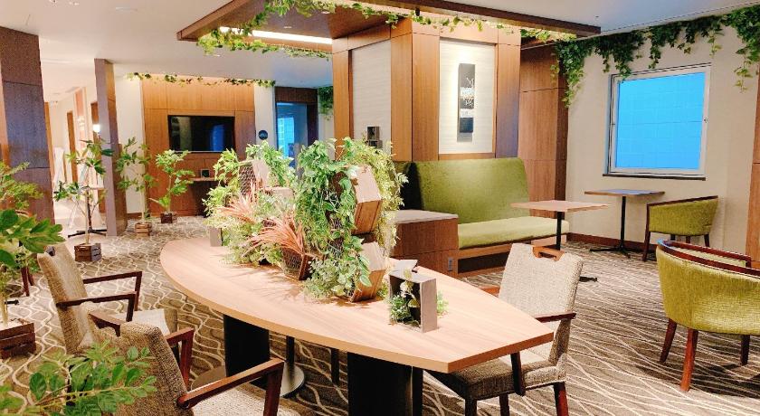 a living room filled with furniture and plants, Hotel Keihan Tenmabashi in Osaka