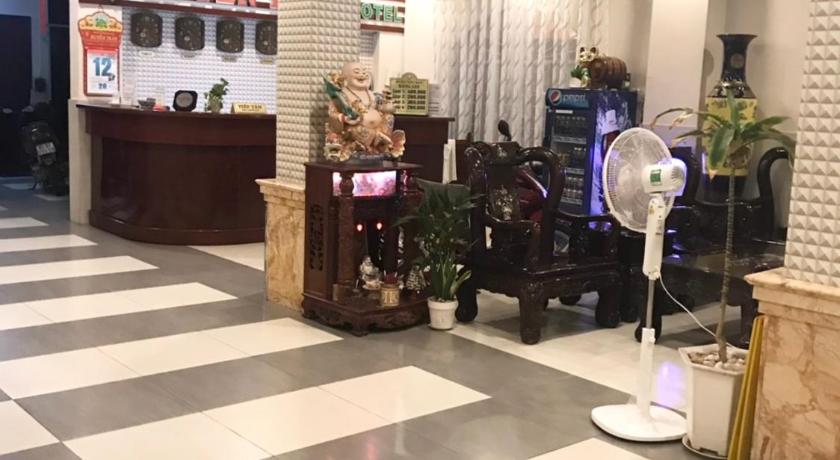 a living room filled with furniture and a clock, Huyen Tran Hotel in Cần Thơ